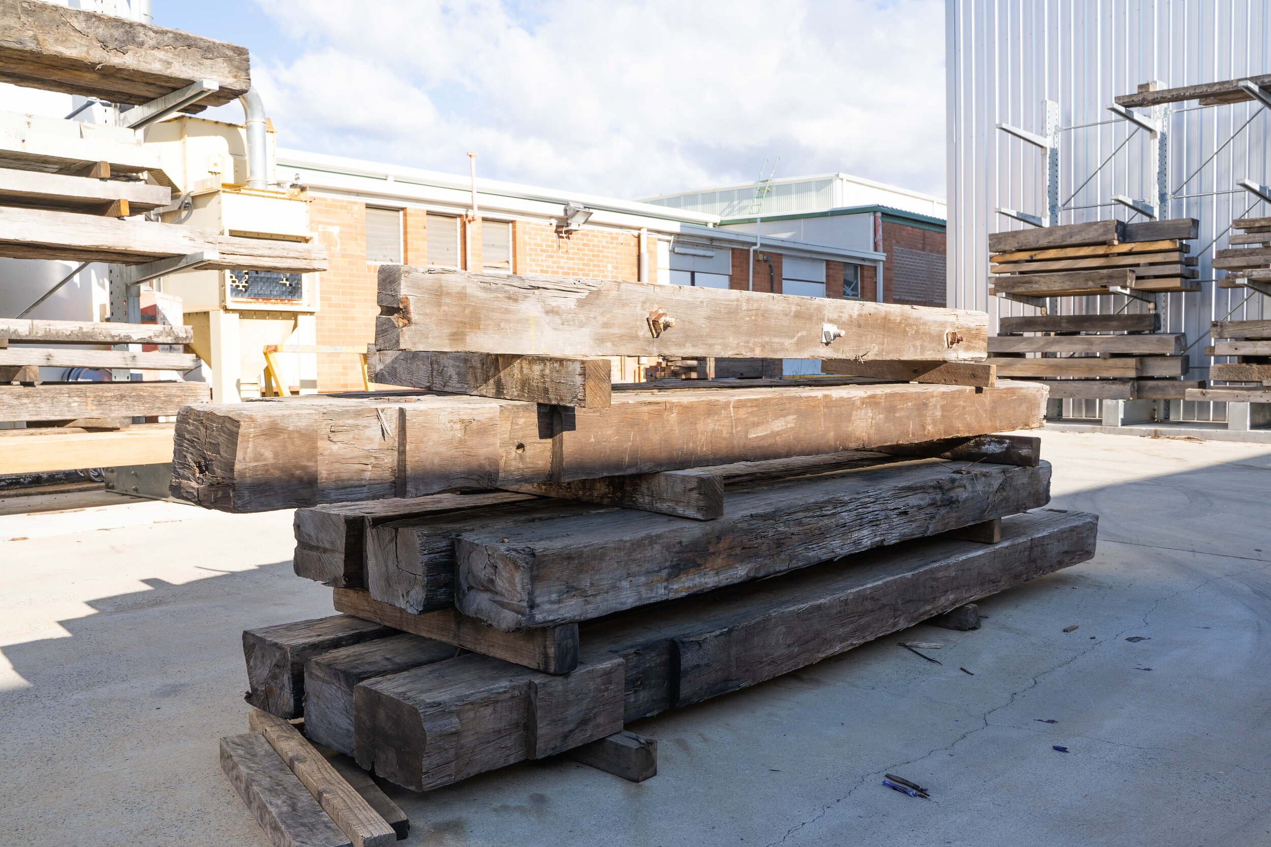 Reclaimed timber stacked in a sustainable scenic workshop